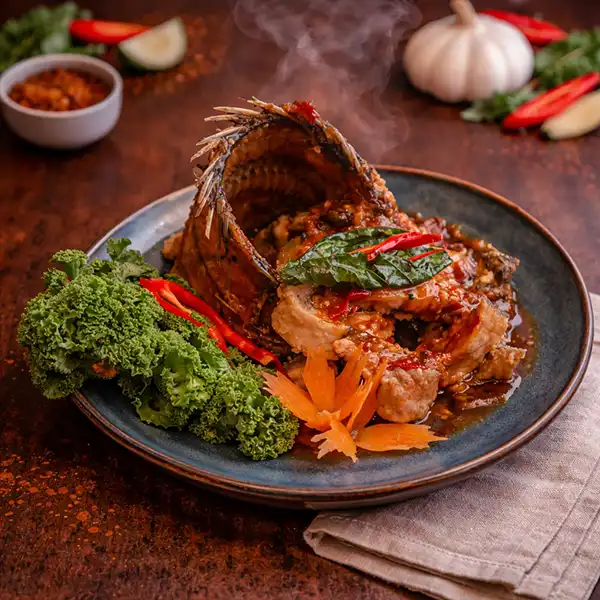 Stir-fried tilapia Pad Cha with chili and Thai herbs at Mae Thai River Stockholm